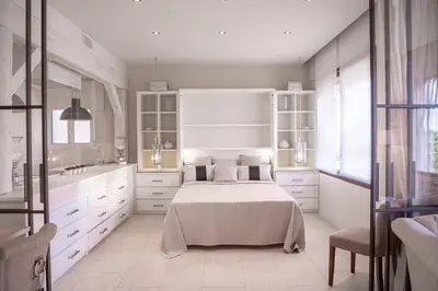 a white kitchen with a bed in a room at 