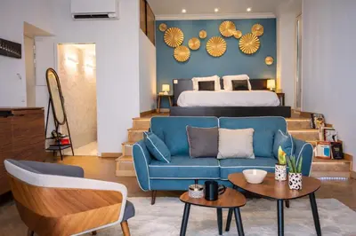 a bedroom with a bed and a tv and a room with a couch at 