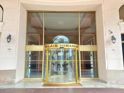 a glass door of a building with a sign that reads miasma at Croisette Beach & Palace in Cannes