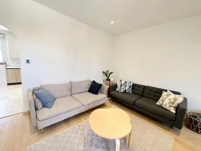 a living room with a couch and a table at Maison de ville tout confort à Cannes et à 10 Minutes à pied de la plage in Cannes