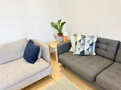 a living room with two couches and a table at Maison de ville tout confort à Cannes et à 10 Minutes à pied de la plage in Cannes