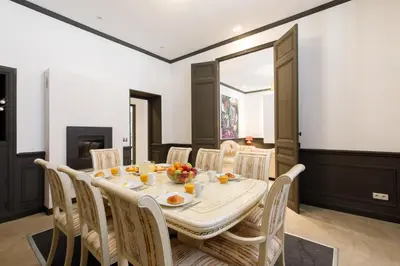 a dining room with a table and chairs at Stylish Town House with 3 bedrooms and private parking in Cannes
