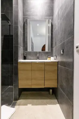 a bathroom with a sink and a mirror at Stylish Town House with 3 bedrooms and private parking in Cannes