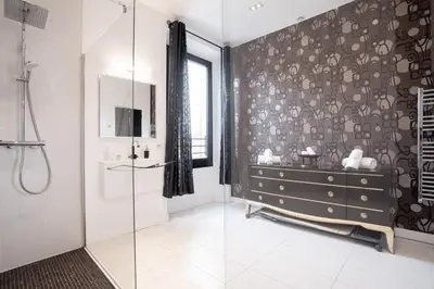 a bathroom with a walk in shower and a dresser at L'EMPEREUR somptueux duplex au style raffiné, Petit Juas, proche du centre in Cannes
