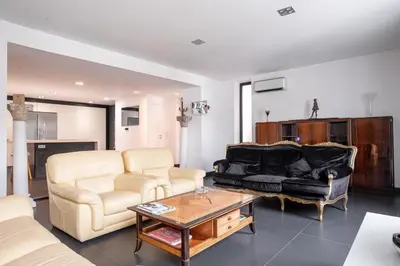 a living room with a couch and a table at L'EMPEREUR somptueux duplex au style raffiné, Petit Juas, proche du centre in Cannes