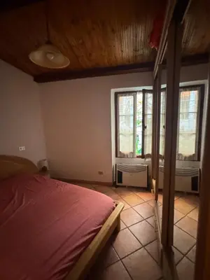 a bedroom with a bed in a room with windows at Le Suquet Appart in Cannes