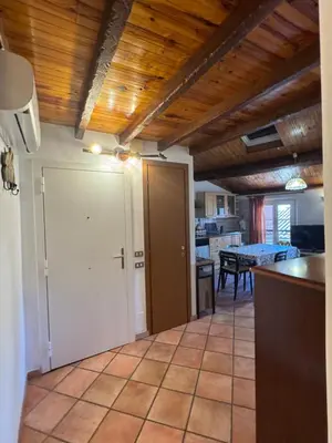 a room with a kitchen with a door and a table at Le Suquet Appart in Cannes