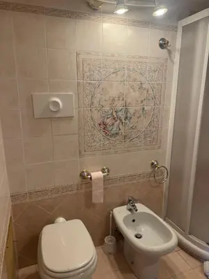 a bathroom with a toilet and a sink at Le Suquet Appart in Cannes