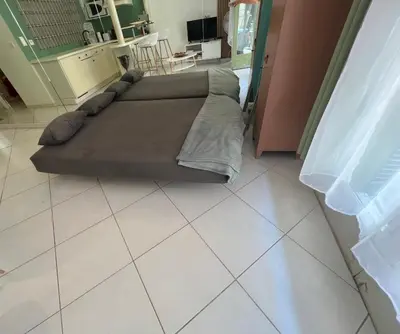 a bedroom with two beds on a tiled floor at Idéal Congrès - 1 min Mer - WIFI - hyper - centre in Cannes