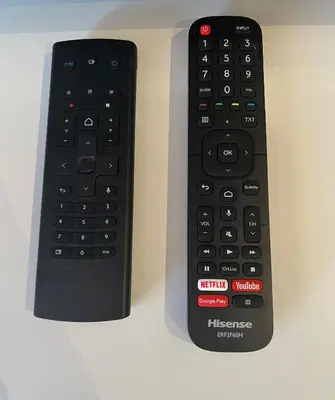 two remote controls sitting next to each other on a table at Idéal Congrès - 1 min Mer - WIFI - hyper - centre in Cannes