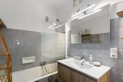 a bathroom with a sink and a tub and a mirror at S 2P CANNES AS - Le Marie Antoinette in Cannes