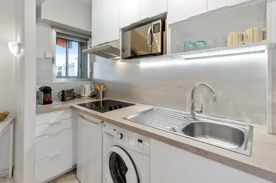 a kitchen with a sink and a washing machine at S 2P CANNES AS - Le Marie Antoinette in Cannes