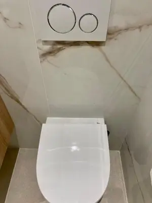 a bathroom with a toilet with two circles on the wall at Cannes - L'Oustaou in Cannes