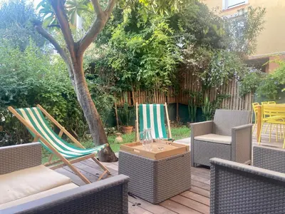 two chairs and a table and chairs on a patio at Cannes - L'Oustaou in Cannes