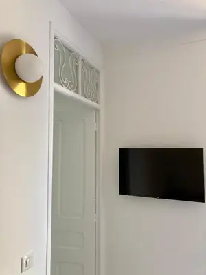 a flat screen tv hanging on a wall next to a door at Cannes - L'Oustaou in Cannes