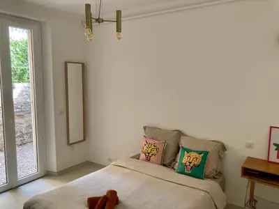 a bedroom with a bed with a stuffed animal on it at Cannes - L'Oustaou in Cannes