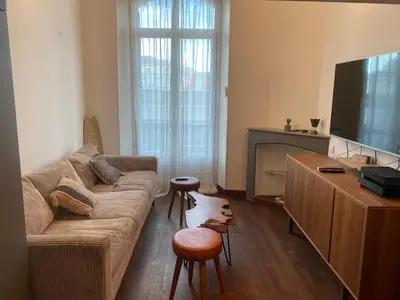 a living room with a couch and a flat screen tv at CANNES CENTRE VILLE- Bel appartement studio + Mezzanine in Cannes
