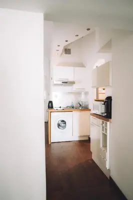 a white kitchen with a washing machine in it at CANNES CENTRE VILLE- Bel appartement studio + Mezzanine in Cannes