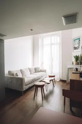 a living room with a couch and tables in it at CANNES CENTRE VILLE- Bel appartement studio + Mezzanine in Cannes