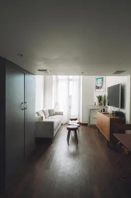 a living room with a couch and a table at CANNES CENTRE VILLE- Bel appartement studio + Mezzanine in Cannes