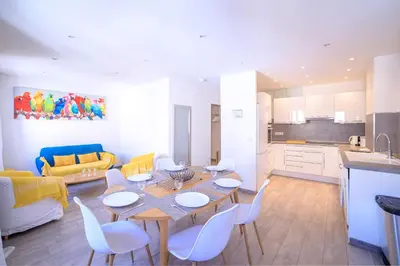 a kitchen and living room with a table and chairs at 21 Rue Meynadier - Meynadier Duplex in Cannes