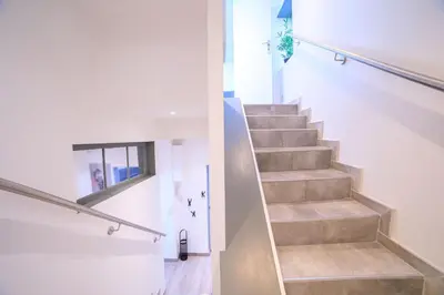 a staircase in a house with white walls and a stair case at 21 Rue Meynadier - Meynadier Duplex in Cannes