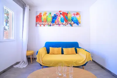 a living room with a yellow couch and a table at 21 Rue Meynadier - Meynadier Duplex in Cannes