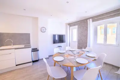 a kitchen and dining room with a table and chairs at 21 Rue Meynadier - Meynadier Duplex in Cannes