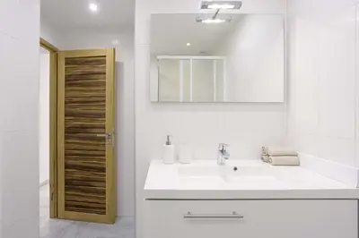 a white bathroom with a sink and a mirror at 21 Rue Meynadier - Meynadier 3p in Cannes
