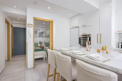a kitchen and dining room with a table and chairs at 21 Rue Meynadier - Meynadier 3p in Cannes