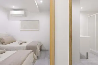 a bedroom with two beds and a mirror at 21 Rue Meynadier - Meynadier 3p in Cannes