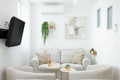 a living room with a white couch and a tv at 21 Rue Meynadier - Meynadier 3p in Cannes