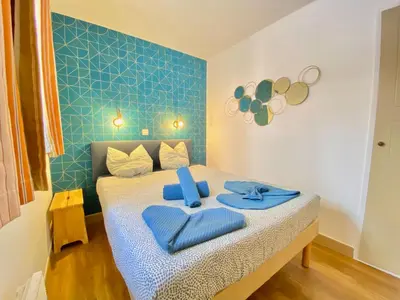 a bedroom with a bed with blue towels on it at Le Delacroix By SCLS Locations in Cannes