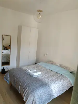a bedroom with a bed with a dresser and a mirror at STUDIO CANNES A 5 MN A PIED DE LA GARE TOUT CONFORT AVEC BALCON in Cannes