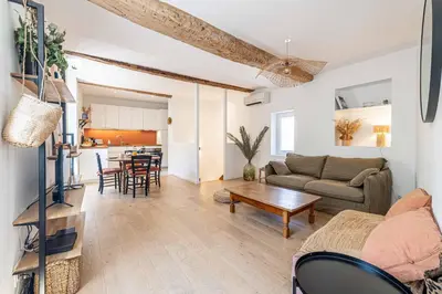 a living room with a couch and a table at L'EMERAUDE duplex confortable au cœur de Cannes, proche plage du Midi et Palais in Cannes