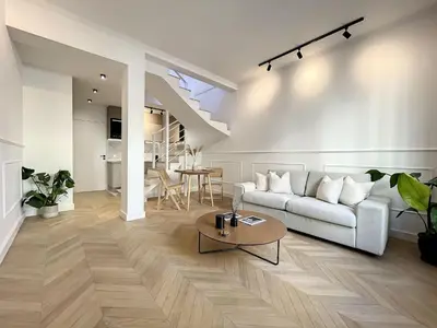 a living room with a white couch and a table at Cannes : Duplex à 5 minutes à pied du Palais des Festivals in Cannes
