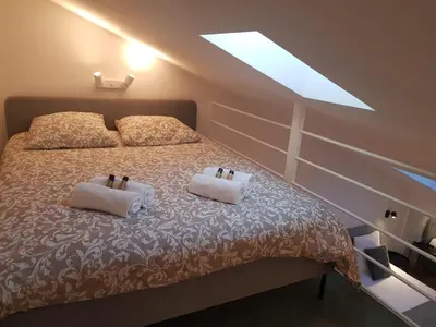 a bedroom with a bed with two pillows on it at Cannes : Duplex à 5 minutes à pied du Palais des Festivals in Cannes