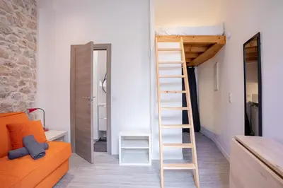 a ladder to a bunk bed in a room with a couch at Cannes Experience Pastour Privatize 6 aparts 10bedrooms&9baths 11doublebeds with his duplexpenthouse ROOFTOP close palais congres beaches et Suquet in Cannes