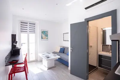 a living room with a bed and a table and a desk at Cannes Experience Pastour Privatize 6 aparts 10bedrooms&9baths 11doublebeds with his duplexpenthouse ROOFTOP close palais congres beaches et Suquet in Cannes