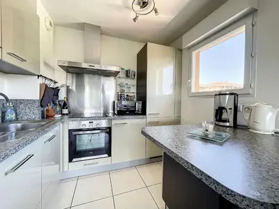 a kitchen with a sink and a stove top oven at Cannes - 2 pièces résidence avec parc et piscine in Cannes
