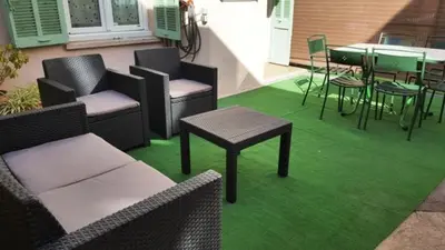 a room with chairs and tables on a green carpet at STUDIOS PARISIENS in Cannes