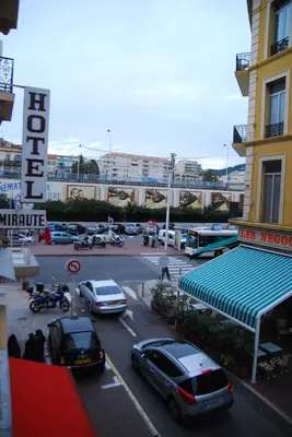 a parking lot with cars parked in front of a building at STUDIOS PARISIENS in Cannes