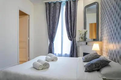 a bedroom with a large white bed with towels on it at Superbe 120m2 au Suquet - Property With Style in Cannes