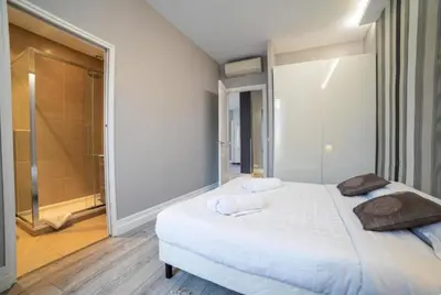 a bedroom with a large white bed and a shower at Superbe 120m2 au Suquet - Property With Style in Cannes