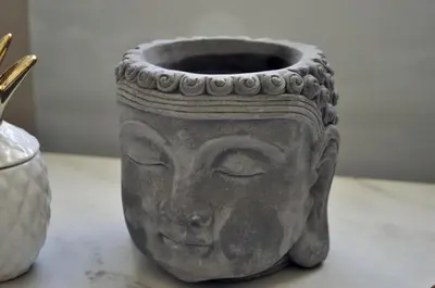 a vase with a face on it sitting on a table at Bright and elegant renovated two rooms - Near Suquet in Cannes