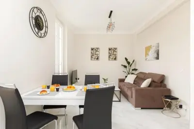 a living room with a table and a couch at Bright and elegant renovated two rooms - Near Suquet in Cannes