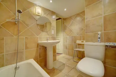 a bathroom with a toilet and a sink and a tub at Townhouse in the heart of the suquet - 4 bedrooms in Cannes