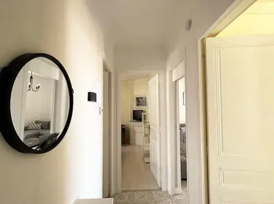 a mirror on a wall next to a hallway at C043-Agréable 3 Pièces proche Croisette et plages in Cannes