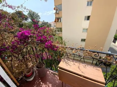 a balcony with purple flowers and a fence at C043-Agréable 3 Pièces proche Croisette et plages in Cannes
