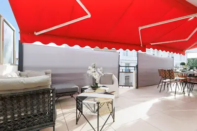a bedroom with a white bed and a large window at XXL 2 beds with XXL terrace next to Martinez Hotel in Cannes
